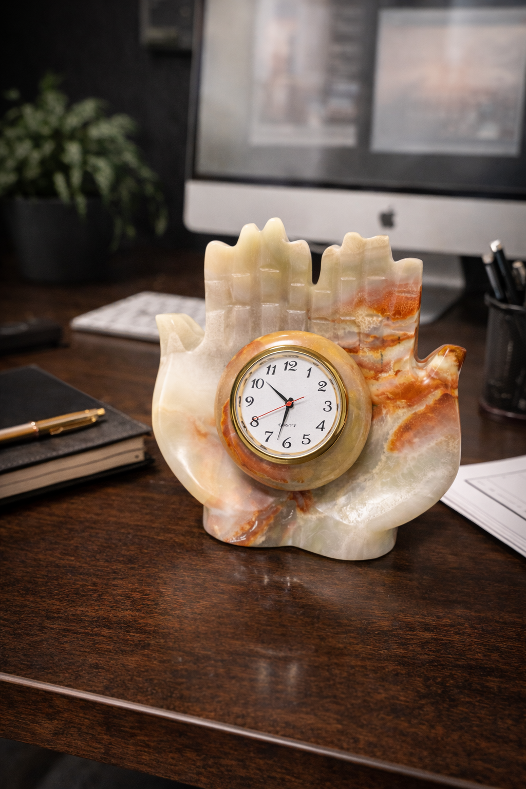 Hand-carved natural onyx hand shaped table clock placed on office desk luxury stone décor piece