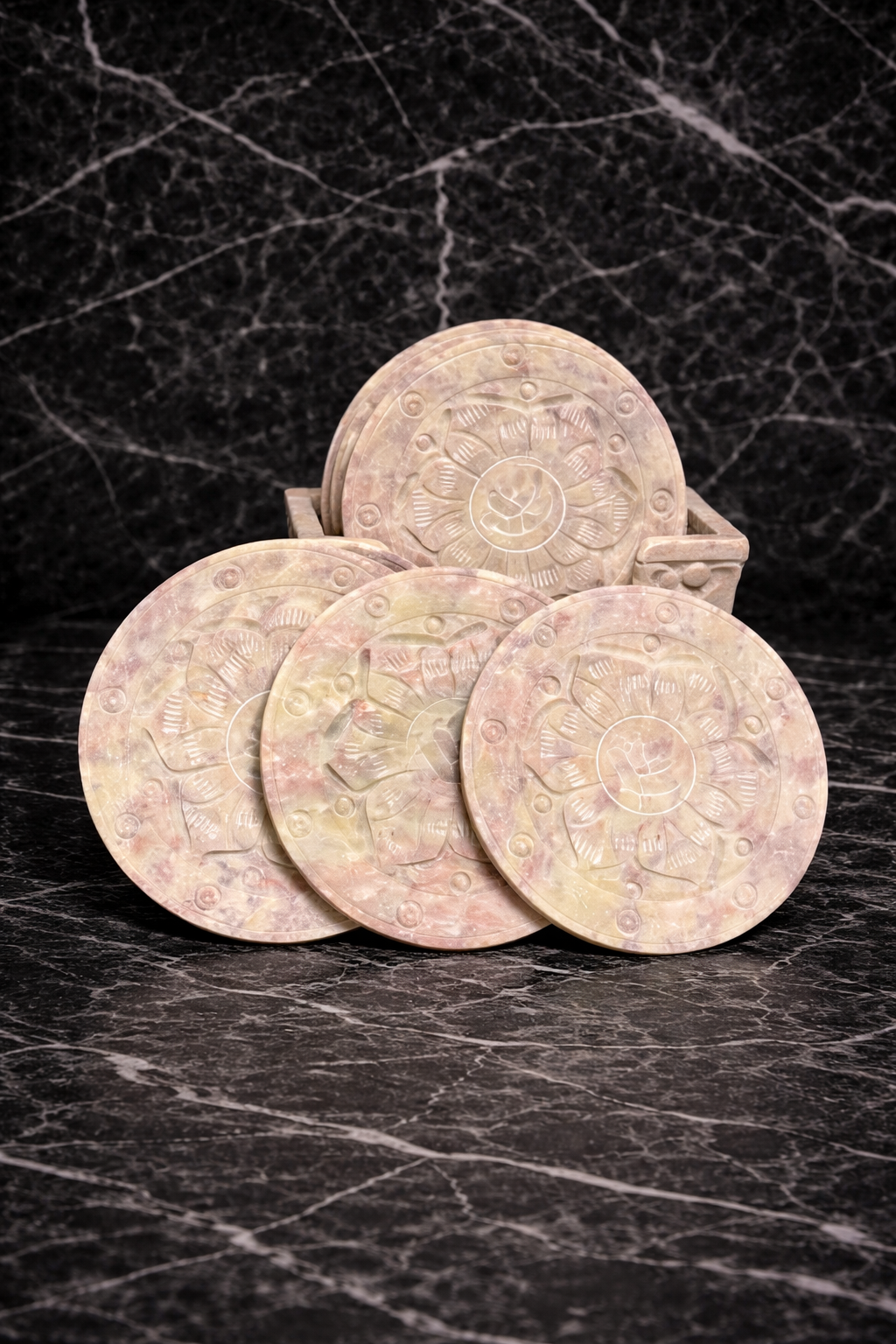 Soapstone lotus design coaster set with carved holder on black marble background