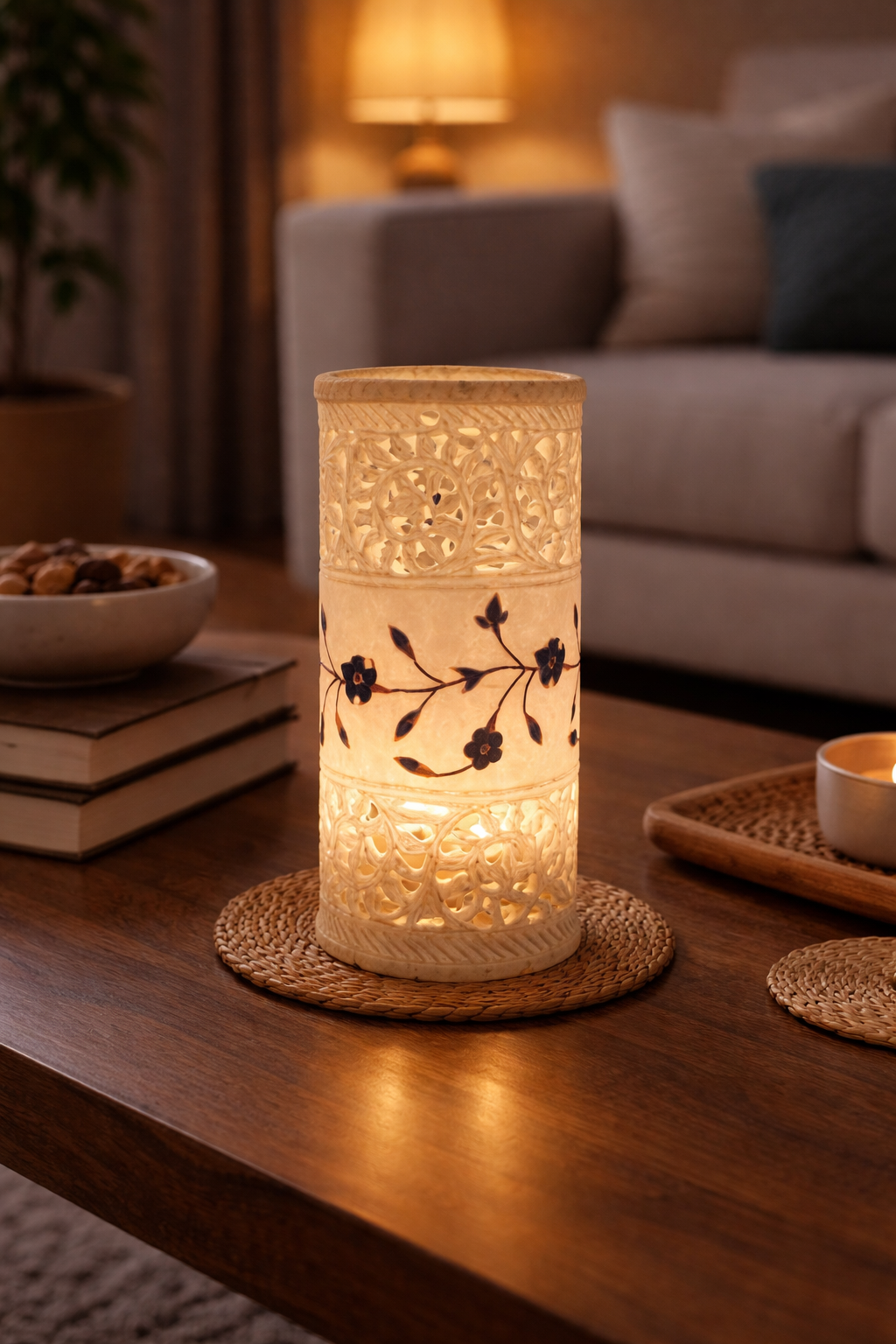 White marble decorative candle holder glowing with intricate carved pattern