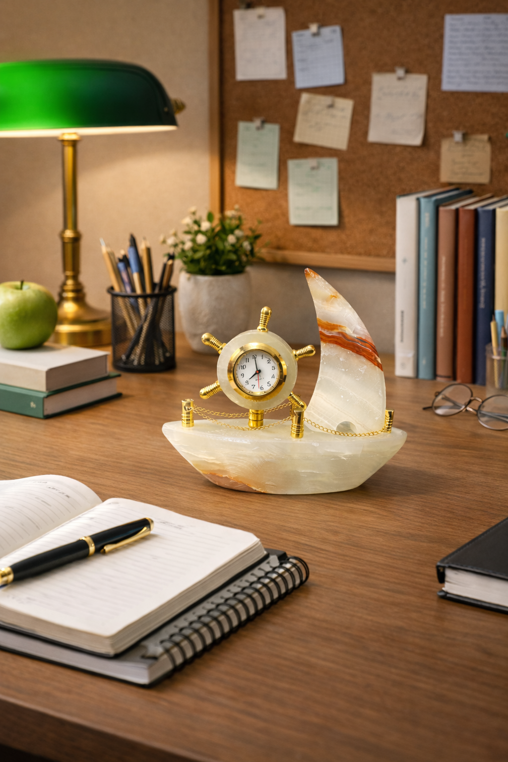 Decorative onyx ship clock on study table with books and lamp, elegant nautical desk decor