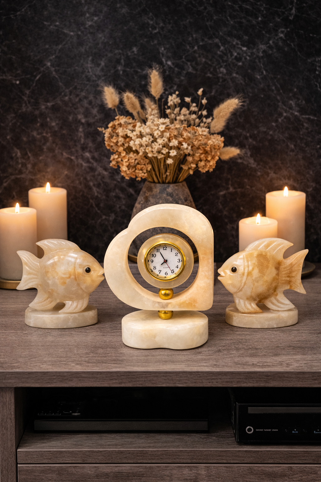 Luxury heart-shaped onyx marble desk clock with decorative stone fish sculptures and candles on console table – elegant modern home décor centerpiece.
