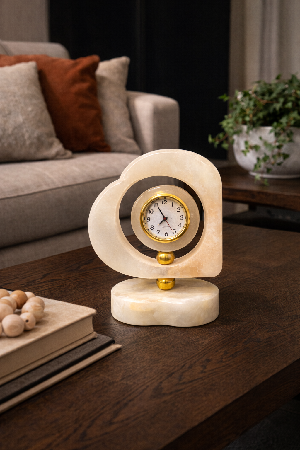 Elegant heart-shaped onyx marble desk clock placed on wooden coffee table in living room – luxury stone décor accent for modern home interiors
