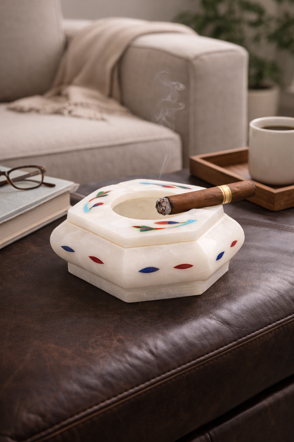 Luxury cigar lounge decor featuring premium marble cigar ashtray with lit cigar