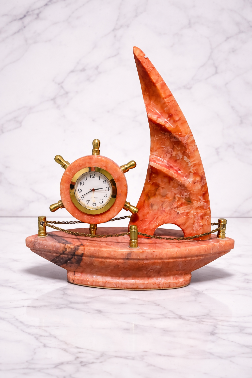 Handcrafted red onyx sailboat desk clock on white marble background – nautical marble décor piece for luxury home interiors.