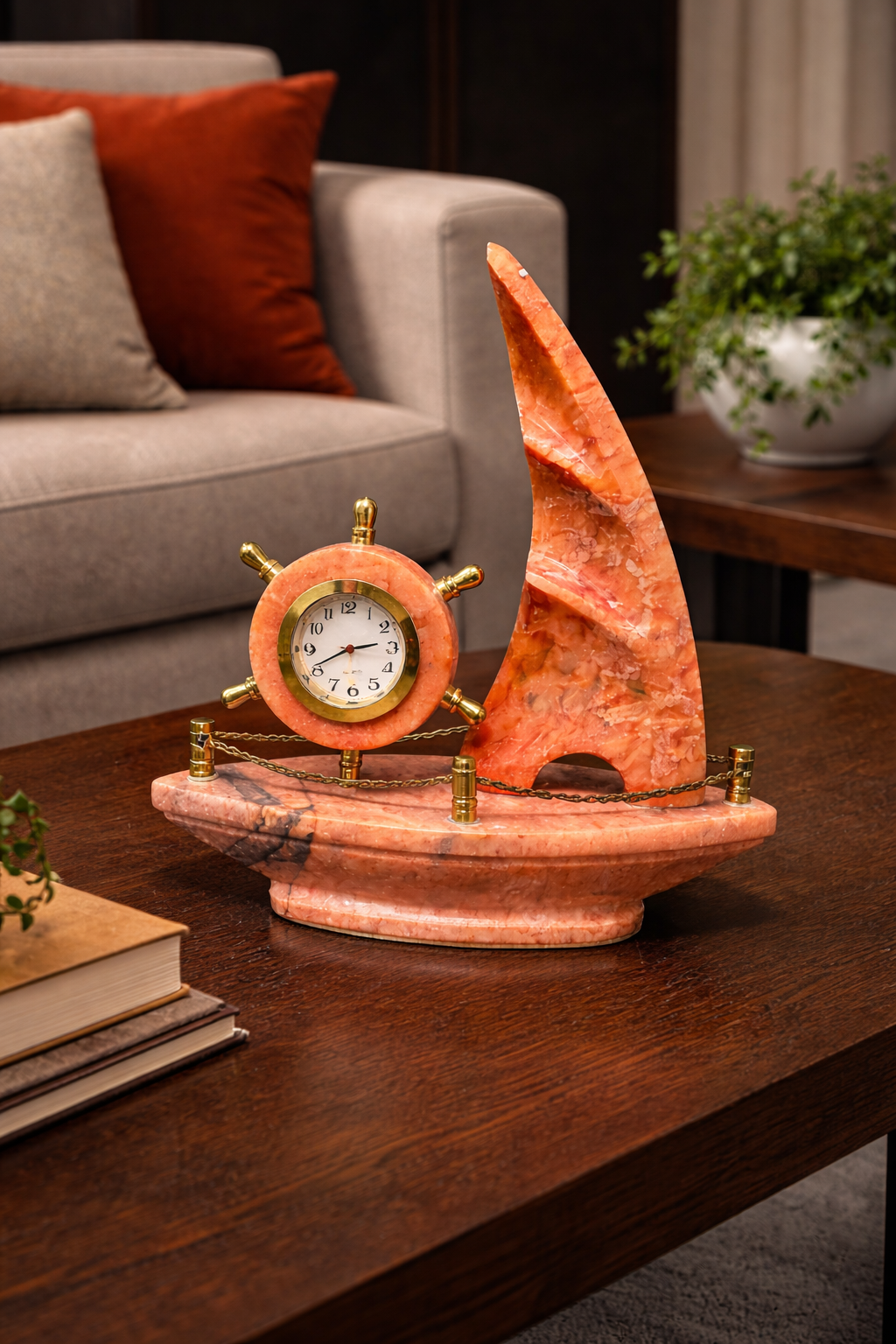 Red onyx sailboat marble clock used as living room table centrepiece – luxury nautical décor accent.