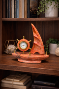 Red onyx sailboat marble clock on study desk with books – unique nautical desk décor.
