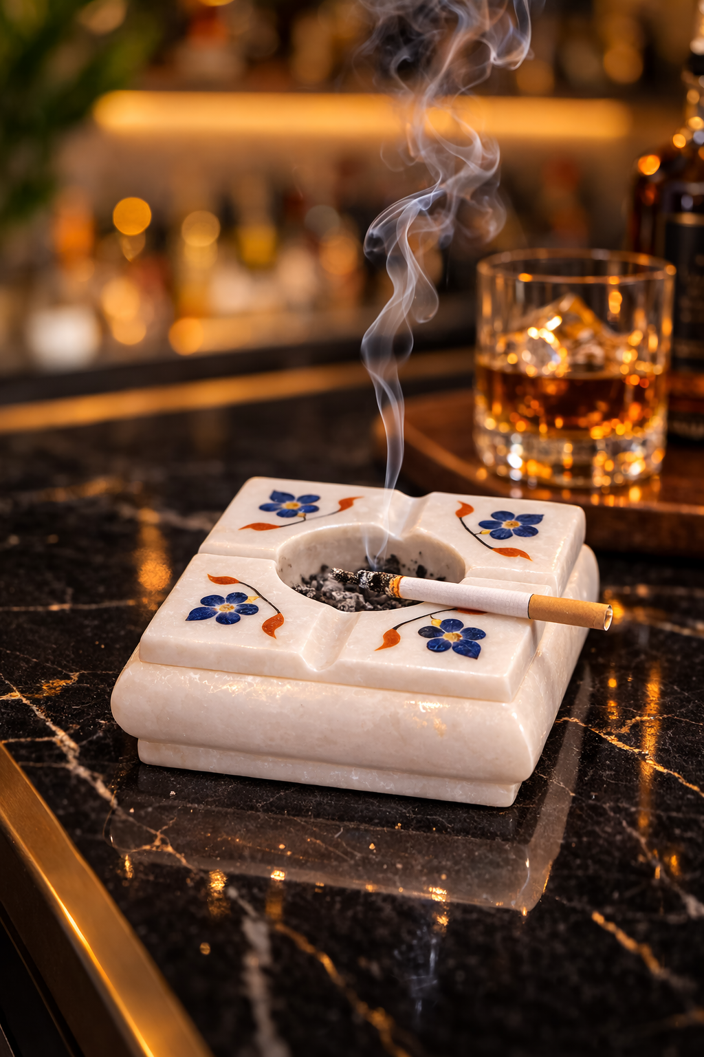 Luxury marble ashtray NZ placed on wicker outdoor lounge table with whiskey glass
