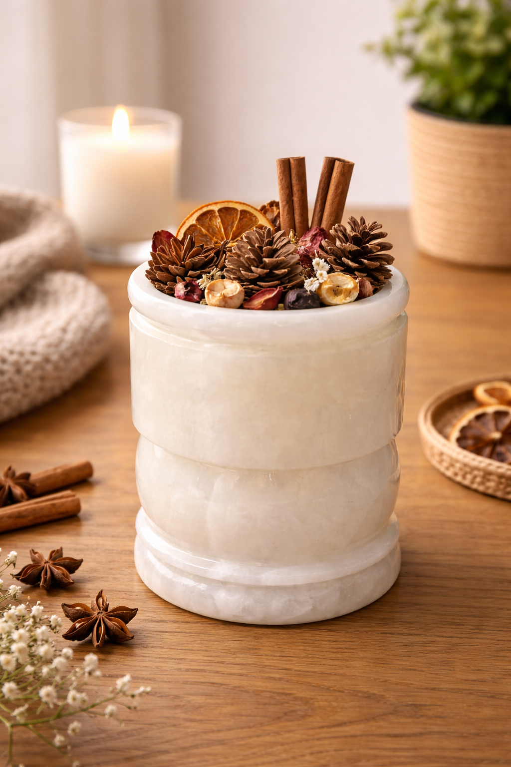 Onyx stone holder filled with decorative potpourri on a wooden console table.
